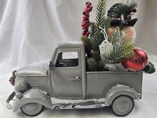 KFD8 - Christmas Snowman, Pine and Ornaments In A Snow Covered Gray Metal Truck