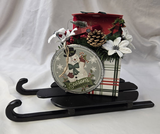 Christmas Gift Arrangement on Black Wooden Sled